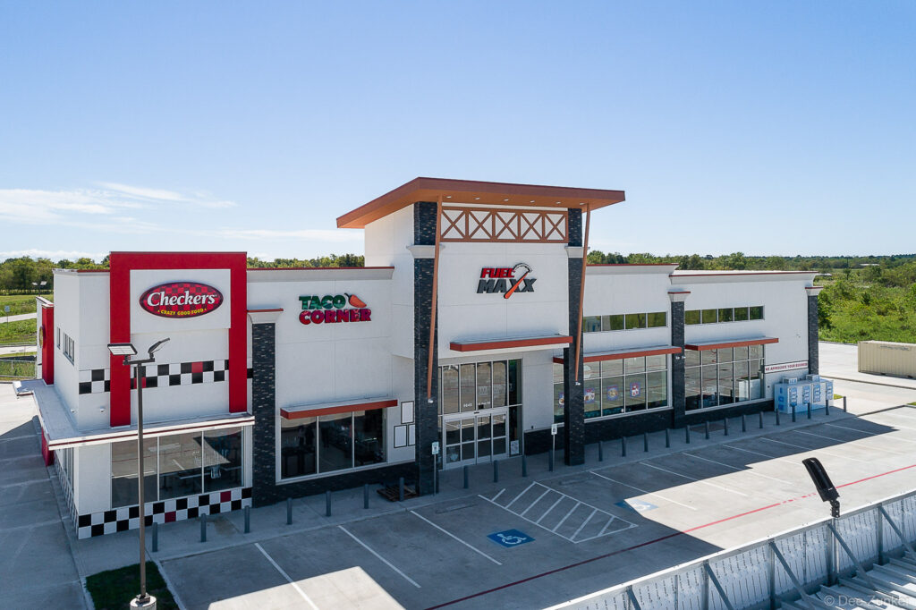 Aerial drone photo of Fuel Maxx convenience store with Checkers and Taco Corner in Dayton TX parking lot view