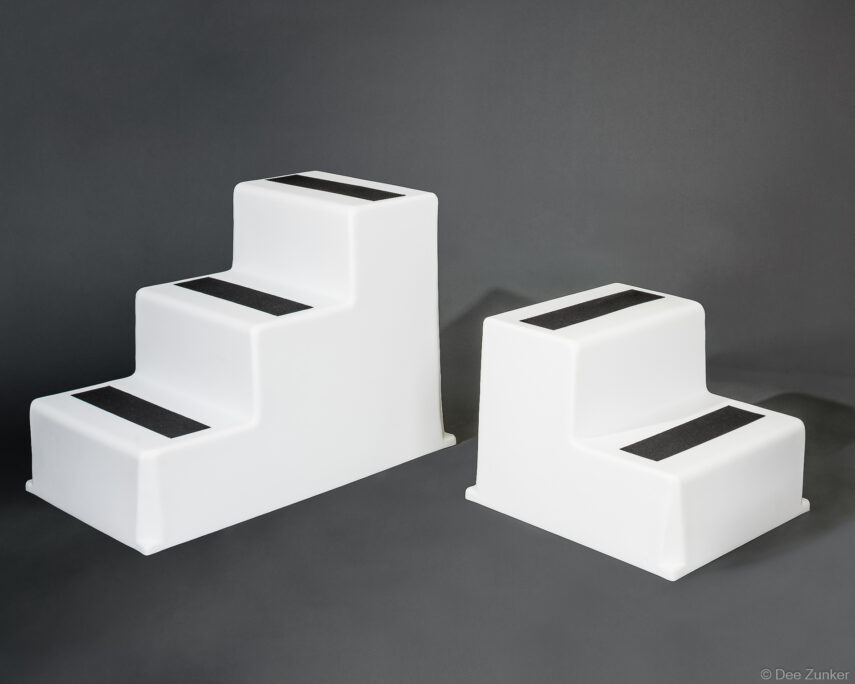 Two white polyethylene marine step boxes with black grip strips, professional product photography on gray background, Houston TX.