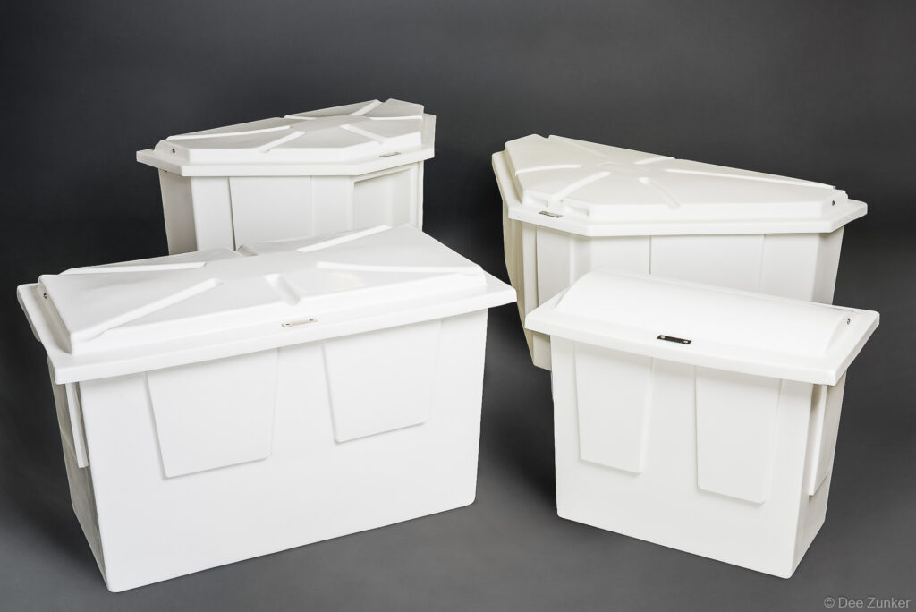 Four white polyethylene marine storage boxes with lids, varying sizes, arranged on gray background, Houston product photography.