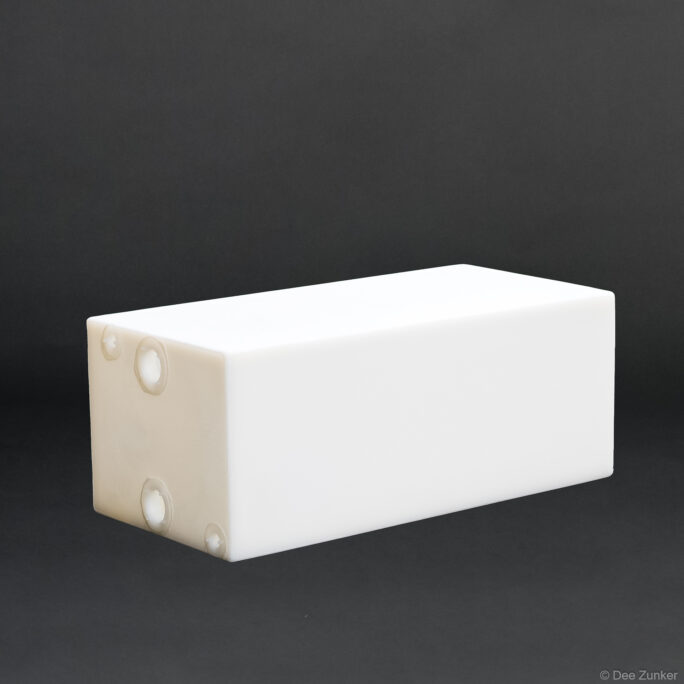 White rectangular polyethylene boat flotation box with molded fittings, shot against gray background for Houston commercial product photography.