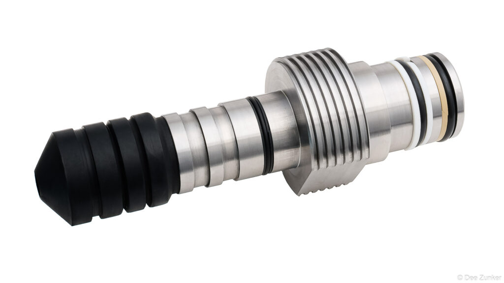 Stainless steel industrial drilling tool with rubber tip and O-ring seals, product photography on white background, Houston TX.