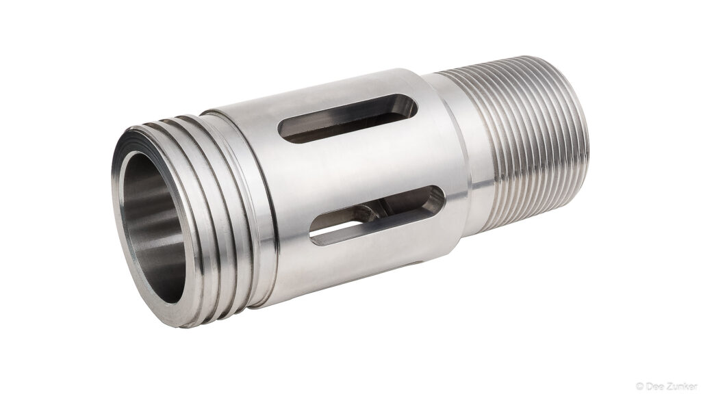 CNC-machined stainless steel drilling tool with threaded end and slotted ports, shot on white background for industrial product photography.