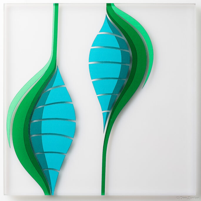 Two layered green and teal leaf-form designs on frosted glass panel, Houston institutional product photography by Dee Zunker.