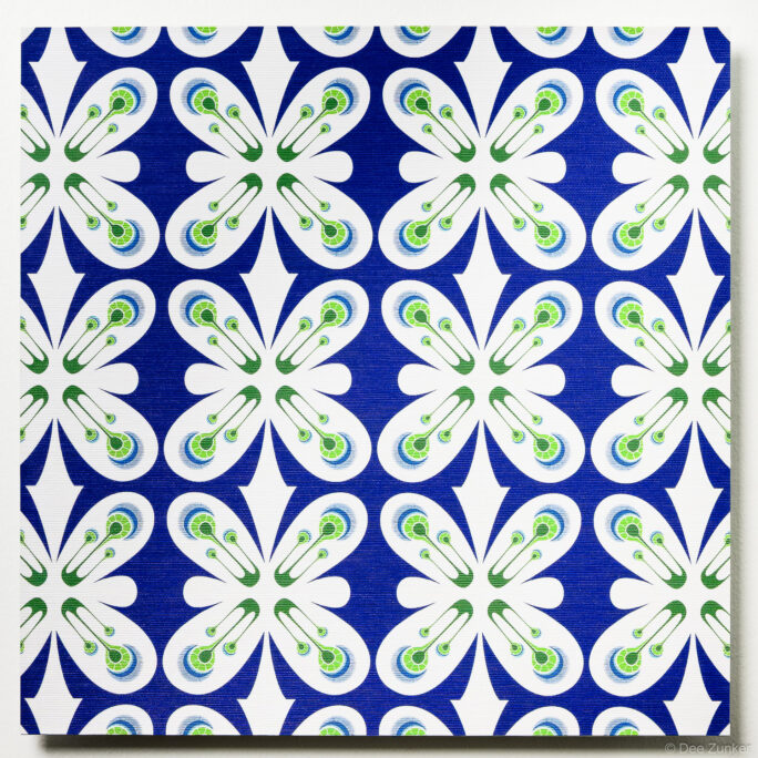 Repeating geometric floral pattern on frosted glass sample in cobalt blue, white, and lime green with safety pin motifs.