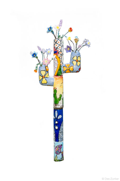 Product photography of a painted ceramic cactus sculpture with floral vases and vibrant folk art motifs, Houston public artwork installation.