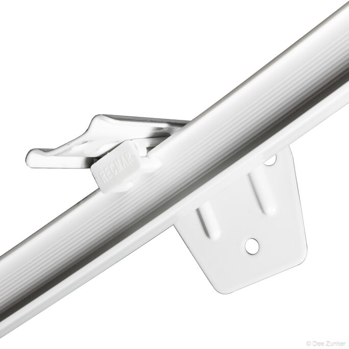 Close-up product photo of a white plastic industrial rail mounting bracket and clip on white background, Houston commercial photography.