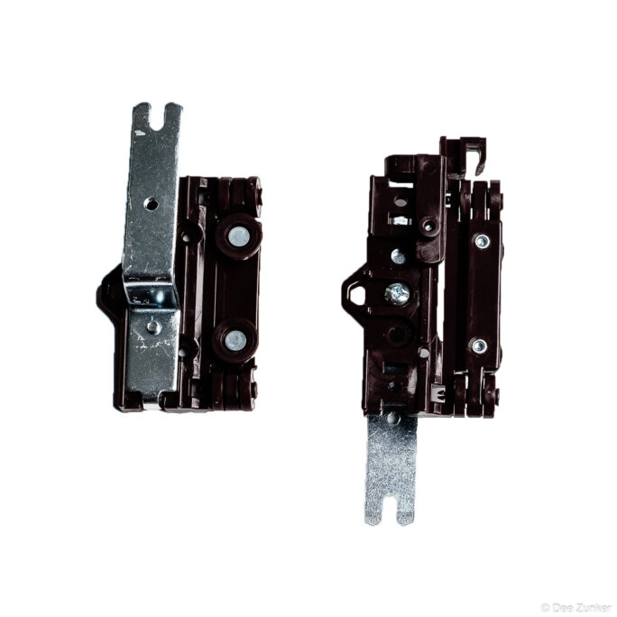 Pair of industrial door hinge assemblies with dark plastic housing and metal brackets photographed on white background for catalog use.