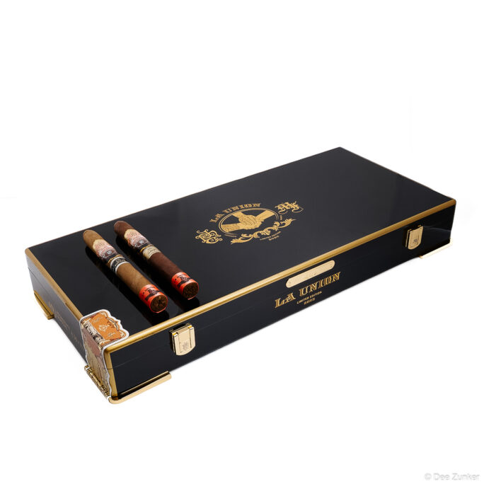 La Union 2023 Limited Edition cigar humidor box in black lacquer with gold trim, open to display premium cigars, Houston product photography.