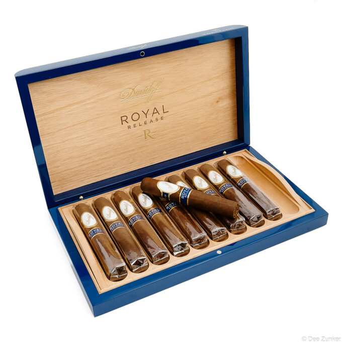 Open Davidoff Royal Release cigar box displaying ten robusto cigars in blue lacquered humidor, Houston product photography on white background.