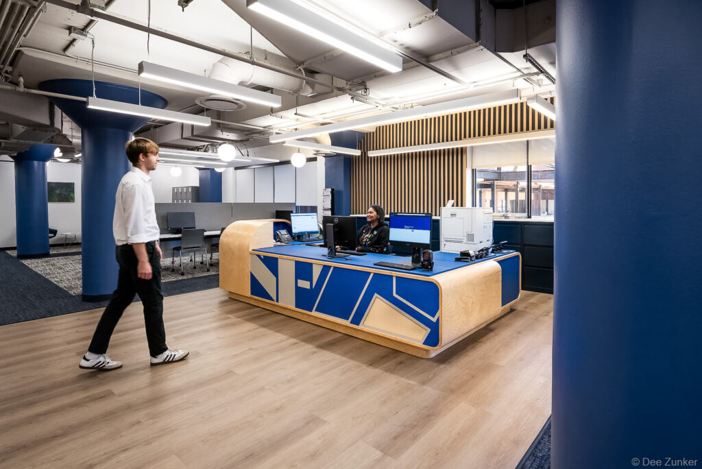 Modern blue and wood reception desk at University of Houston-Downtown library, photographed by Dee Zunker architectural interior photography.