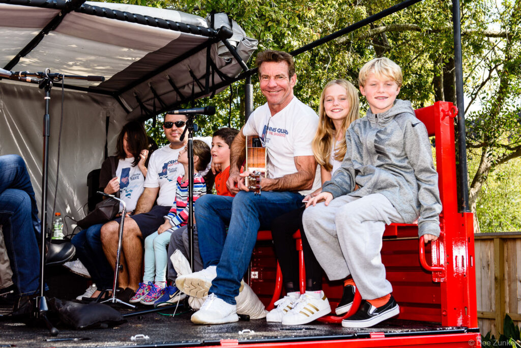 Dennis Quaid with his twins sit in the back of the City of Bellaire high water vehicle to kickoff the Bellaire Block Party on November 11, 2017.