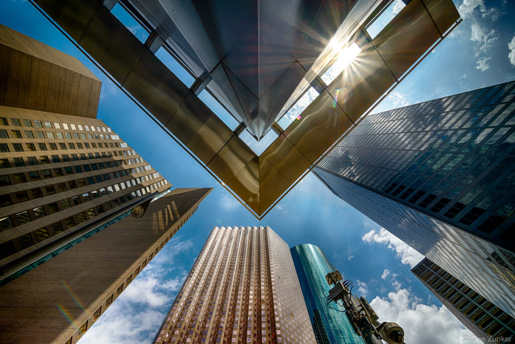 Looking through one of the 2 the awnings on the corners of the Total Plaza built 1971, renovated 1999. The Hyatt Regency, Enterprise Plaza, Wells Fargo Tower, and the Centerpoint Energy Plaza surround the corner of Total Plaza. by Houston Architectural Photographer Dee Zunker
