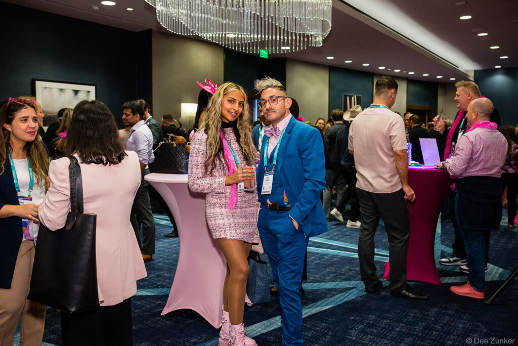 Attendees in Barbie-themed pink outfits network at the INTA Foundation Barbie Fundraiser, photographed by Dee Zunker Photography.