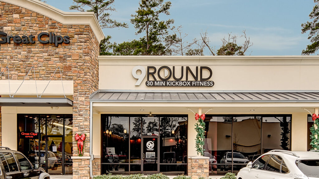 Exterior storefront of a kickboxing fitness studio in The Woodlands TX retail strip center with holiday decorations