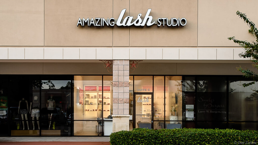 Exterior storefront of a lash studio in a retail strip center in The Woodlands TX, photographed for a commercial portfolio