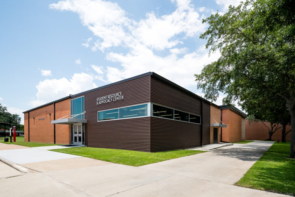 Exterior view of the Lee College Student Resource and Advocacy Center in Baytown TX featuring modern corrugated metal cladding and brick facade