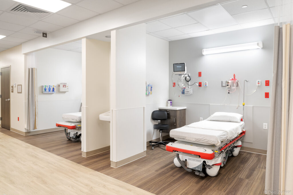 Newly renovated emergency department patient bays with hospital stretchers, medical monitoring equipment, and clean modern interiors in Houston.