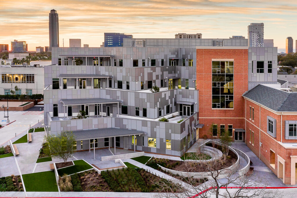 River Oaks Baptist School modern addition at twilight with Cornerstone metal panel cladding and brick facade, Houston architectural exterior photography